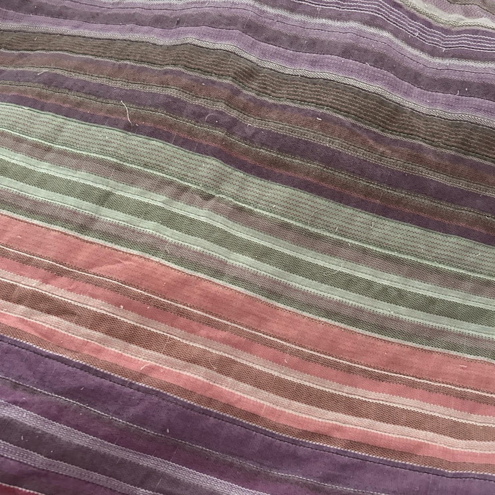 Vintage quilt. Multicolored striped. Purple underside. 75”X 65”.
